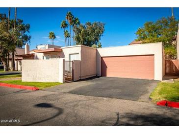 Inviting single-story home featuring a two-car garage, secure courtyard, and a well-maintained yard at 2140 E Rosarita Dr, Tempe, AZ 85281