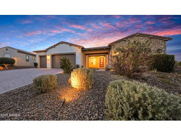 Charming single-story home with desert landscaping and a warm, inviting entrance at twilight at 29348 N Clear Ridge Rd, Rio Verde, AZ 85263