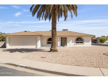 Charming single-story home featuring a neutral-toned exterior, well-kept landscaping, and a welcoming entrance at 4662 E Escondido Ave, Mesa, AZ 85206