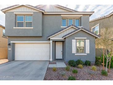 Charming gray two-story home featuring a two-car garage and landscaped front yard at 9303 E Static Ave, Mesa, AZ 85212