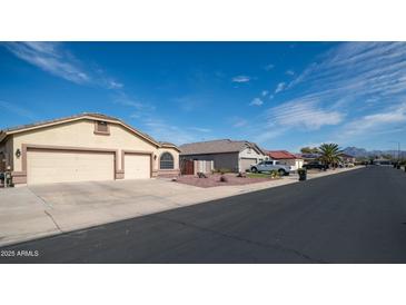 Charming single-story home with well-maintained front yard and attached two-car garage at 11460 E Dartmouth St, Mesa, AZ 85207