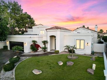 Charming home featuring a well-manicured front yard with lush greenery and updated landscaping details at 1157 N Date Palm Dr, Gilbert, AZ 85234