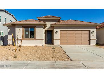 Charming single-story home with a well-maintained yard and a two-car garage on a sunny day at 31541 N Wet Creek Rd, San Tan Valley, AZ 85143