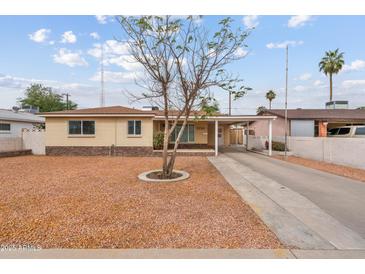 Charming single-story home with a low-maintenance rock front yard and long driveway at 3718 E Sheridan St, Phoenix, AZ 85008