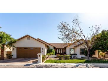 Charming single-story home featuring a well-manicured lawn, desert landscaping, and a two-car garage at 4217 E Edgemont Ave, Phoenix, AZ 85008