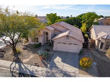 Charming single Gathering home featuring a desert landscape, a tile roof, and a two car garage at 4741 W Kristal Way --, Glendale, AZ 85308