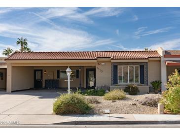 Charming single-story home with desert landscaping, tile roof, and covered carport on a sunny day at 5110 N 78Th St, Scottsdale, AZ 85250