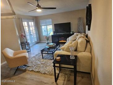 Cozy living room with neutral tones, stylish decor, and ceiling fan, creating a warm, inviting atmosphere at 5518 E Lindstrom Ln # 3012, Mesa, AZ 85215