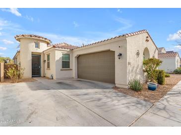 Charming home showcasing a two-car garage, turret entry and low maintenance desert landscaping at 5637 S 29Th Pl, Phoenix, AZ 85040