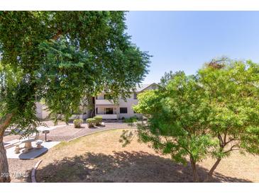 Exterior view of a two-story condo with mature landscaping and common areas at 616 S Hardy Dr # 220, Tempe, AZ 85281