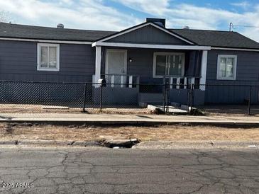 Charming single-story home with a fenced yard, offering a blend of comfort and security at 619 W Cocopah St, Phoenix, AZ 85003