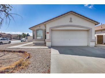 Charming single-story home with a two car garage and desert landscaping at 6557 W Puget Ave, Glendale, AZ 85302