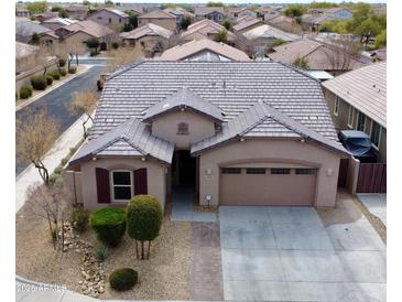 Charming single-story home featuring a well-maintained front yard and a two-car garage at 7609 W Whitehorn Trl, Peoria, AZ 85383