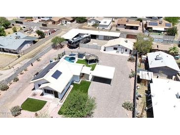 Aerial view of home showcasing a pool, spa, gazebo, RV parking, and metal roof in a desert landscape at 1102 E Brown St, Phoenix, AZ 85020