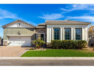 Beautifully designed single-Gathering home with manicured landscaping and a welcoming facade on a sunny day at 1143 N Quinn --, Mesa, AZ 85205