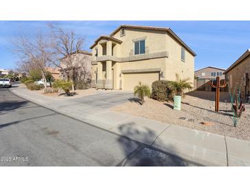 Inviting two-story home boasting a neutral stucco exterior, well-manicured landscaping, and a convenient two-car garage at 1200 E Country Crossing Way, San Tan Valley, AZ 85143