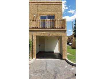 Two-story home featuring a balcony and covered parking at 12245 N 21St Ave # 4, Phoenix, AZ 85029