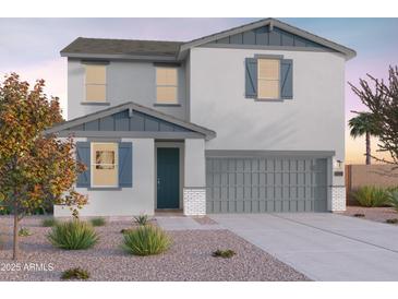 Two-story home boasts neutral stucco, blue trim, and drought-resistant landscaping, enhancing curb appeal at 12551 W Parkway Ln, Avondale, AZ 85323