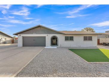 Charming single-story home with a well-maintained front yard and a two-car garage at 16239 N 47Th Dr, Glendale, AZ 85306