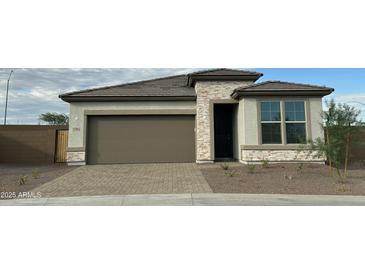 Charming single-story home featuring a two-car garage and stylish stone accents at 17916 W Puget Ave, Waddell, AZ 85355