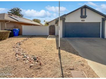 Charming single-story home featuring a gravel front yard and a two-car garage at 1805 E Bluefield Ave, Phoenix, AZ 85022