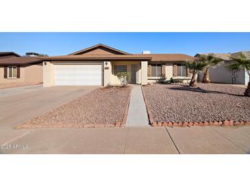 Charming single-story home featuring a two-car garage, desert landscaping, and well-maintained exterior at 2305 S Orange --, Mesa, AZ 85210