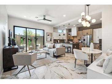 Bright open-concept living room with a modern kitchen, white marble floors, and stylish furnishings at 377 E Windsor Ave # 2, Phoenix, AZ 85004