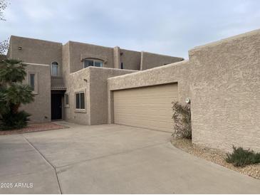 Two-story stucco home with a neutral color scheme, complemented by well-maintained landscaping and an attached two-car garage at 4107 E Charter Oak N Rd, Phoenix, AZ 85032