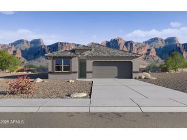 Charming single-story home with a two-car garage, low-maintenance desert landscaping and mountain views at 469 W Freedom St, Florence, AZ 85132