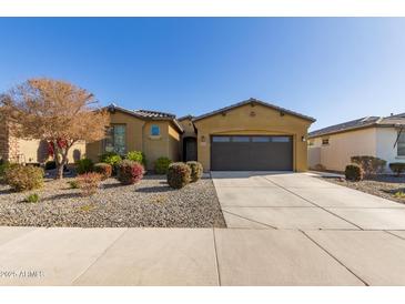 Inviting single-story home with a well-manicured xeriscaped front yard and covered entryway at 5325 N 188Th Ave, Litchfield Park, AZ 85340