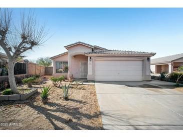 Charming single-story home with a tile roof, desert landscaping, and a two-car garage at 7557 W Colter St, Glendale, AZ 85303