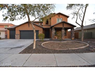 Charming two-story home with a three car garage and desert landscaping at 8776 W Peppertree Ln, Glendale, AZ 85305