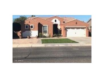 Charming home featuring a well-maintained front yard, a two-car garage and tasteful southwestern architecture at , Gilbert, AZ 85234