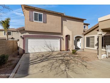 Two-story home with a two-car garage, charming arched entry and desert landscaping at 1576 E Jasper Ct # E, Gilbert, AZ 85296