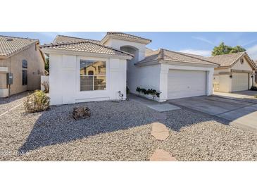 Charming single-story home with well-maintained landscaping and a tile roof at 1881 E Erie St, Chandler, AZ 85225