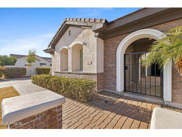 Charming front entrance with brick accents, arched gate and manicured landscaping at 253 W Malibu Dr, Chandler, AZ 85248