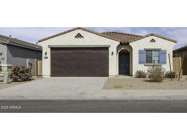 Charming single-story home with a brown garage door, blue accents, and desert landscaping at 35378 W Santa Barbara Ave, Maricopa, AZ 85138