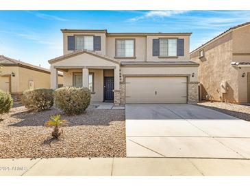 Charming two-story home with a two-car garage, neutral-colored facade, and low-maintenance landscaping at 38179 W La Paz St, Maricopa, AZ 85138