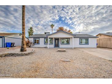 Charming single-story home with neutral exterior and low maintenance desert landscaping at 3915 E Hillery Dr, Phoenix, AZ 85032