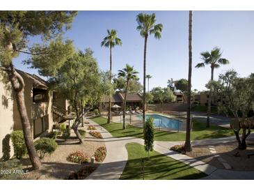 Inviting pool area surrounded by lush landscaping and walkways, offering a serene outdoor space at 5877 N Granite Reef Rd # 2243, Scottsdale, AZ 85250