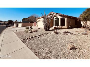 Charming single-story home with desert landscaping, spacious driveway and two car garage at 6458 W Adobe Dr, Glendale, AZ 85308