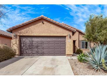 Charming home with a two-car garage, desert landscaping, and a well-maintained yard at 7946 W Sonoma Way, Florence, AZ 85132