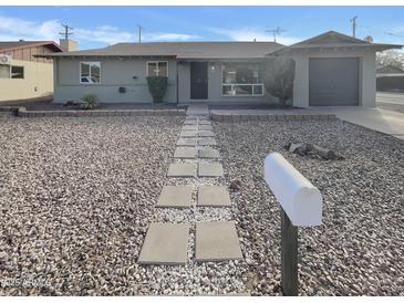 Charming home featuring low-maintenance landscaping and walkway leading to the front entrance at 9023 N 18Th Ave, Phoenix, AZ 85021