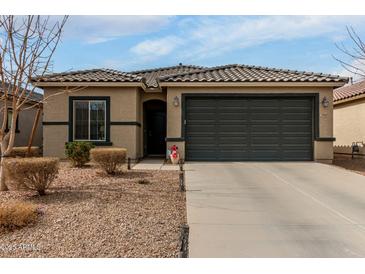 Charming single-story home featuring a well-maintained front yard and a two-car garage at 18644 N Desert Willow Dr, Maricopa, AZ 85138