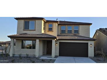 Two-story home featuring a neutral-toned exterior, covered entry, and two-car garage at 19201 W Missouri Ave, Litchfield Park, AZ 85340