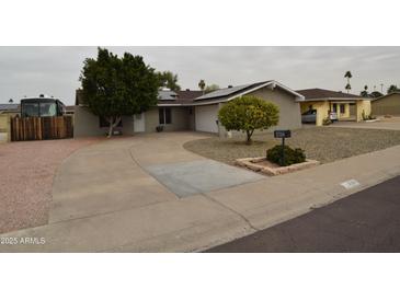 Charming single-story home featuring a well-manicured front yard and a circular driveway at 3708 W Redfield Rd, Phoenix, AZ 85053