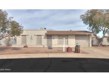 Charming single-story home with a well-maintained yard and inviting curb appeal, garage, neutral colors and rock details at 406 E Saguaro St, Casa Grande, AZ 85122