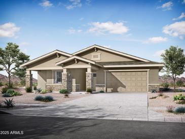Charming single-story home featuring desert landscaping, a two car garage, and stone accents on the front porch columns at 44319 N 43Rd Dr, Phoenix, AZ 85087