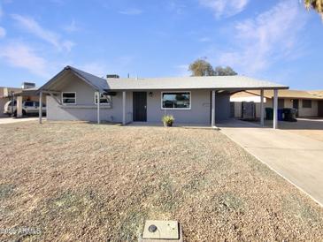 Charming single-story home with a well-maintained gravel yard and covered front entrance, showcasing classic curb appeal at 470 S Daley --, Mesa, AZ 85204
