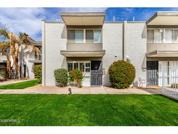 Charming condo with a well-manicured lawn and cozy front entryway at 7720 E Heatherbrae Ave # 13, Scottsdale, AZ 85251